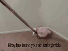 kirby is laying on the floor with a sword in his mouth .