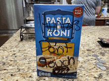 a box of pasta with roni on a counter