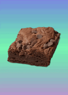 a brownie with chocolate chips on top of it on a blue and green background