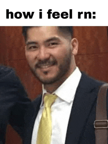 a man in a suit and tie is smiling and looking at the camera .