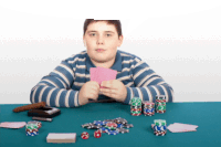 a boy is playing poker with a pile of chips