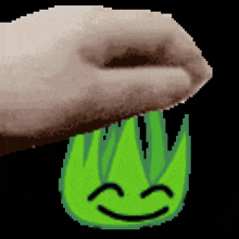 a pixel art of a hand holding a green flame with a smiling face