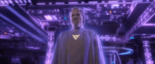 a man in a purple robe is standing in a room with a purple background .