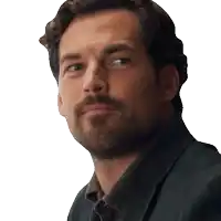 a man with a beard is wearing a suit jacket