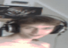 a man wearing headphones is smiling in a blurry picture .