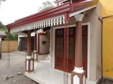 a house with a porch and a roof that has a chain hanging from it