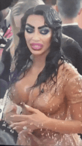 a woman in a very revealing dress is covered in water