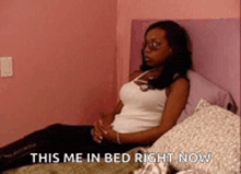 a woman is sitting on a bed with the words " this me in bed right now "