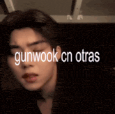 gunwook cn otras is written on the face of a young man