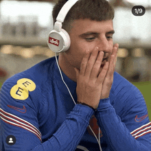 a man wearing headphones has a sticker on his shirt that says ' e7 m '