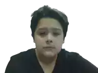 a young boy wearing a black shirt is looking at the camera