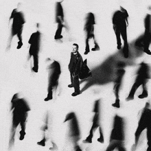 a blurry photo of a man standing in a crowd