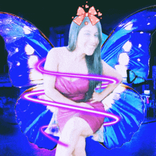 a woman in a pink dress with blue butterfly wings