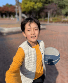 a young boy is holding a basketball that says size 7