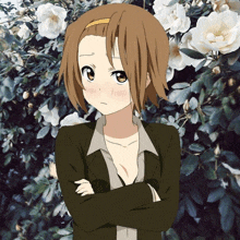 a girl with brown hair is standing in front of a bush of white flowers