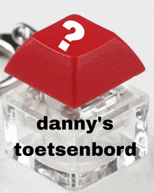 a red keyboard key with a question mark and the words danny 's toetsenbord below it