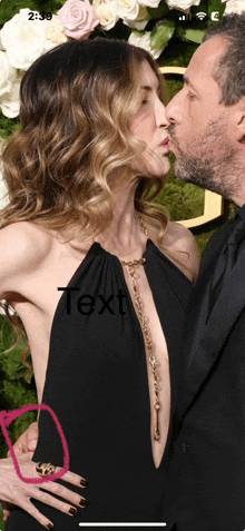 a man kissing a woman on the cheek with the word text visible in the corner