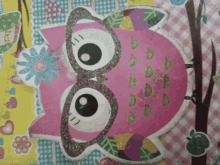 a pink owl with glasses and a flower on its face