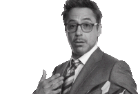 a man wearing glasses and a suit is making a funny face