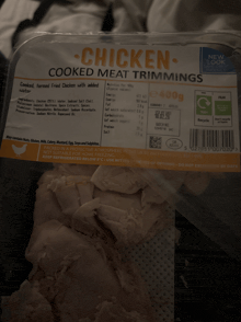 a package of cooked meat trimming chicken sits in a plastic container