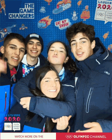 a group of young people are posing for a photo in front of a wall that says ' the game changers ' on it