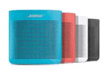 four bose speakers in different colors are lined up in a row