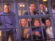 a group of people looking out of a window