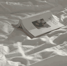 a book laying on a bed that says 365 on the cover