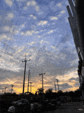 a sunset with a lot of power lines and pipes