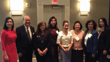 a group of people posing for a picture with one woman wearing a name tag that says ' amanda ' on it