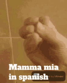 a fist with the words mamma mia in spanish written on it