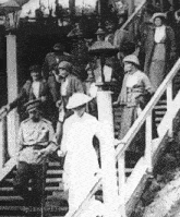 a black and white photo of a group of people walking down stairs with the words " delicateflower " at the bottom