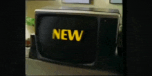 a black television with the word new on the screen