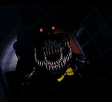 a nightmare bonnie from five nights at freddy 's with red eyes and sharp teeth is standing in the dark .