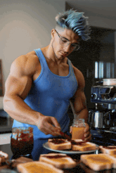 a man in a blue tank top spreads jam on toast