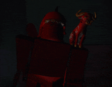 a stuffed animal with horns is standing next to a red robot