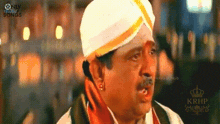 a man wearing a white hat and a yellow ribbon around his head .