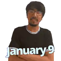 a man wearing glasses and a black shirt with the date january 9 on it