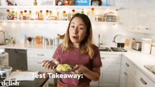 a woman is holding a plate of food in a kitchen with the words test takeaway written on the bottom