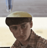 a man in a plaid shirt is looking at the camera with a pen on his head