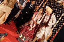 a bride and groom are holding hands during a wedding ceremony