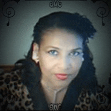 a close up of a woman 's face with a leopard print jacket .