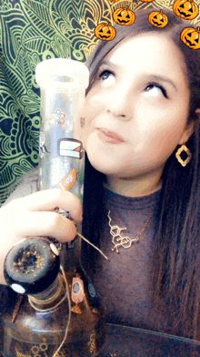 a woman is holding a bong with a sticker on it that says ' u ' on it