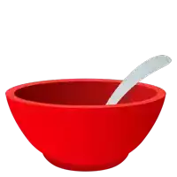 a red bowl with a silver spoon inside of it