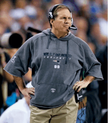 a man wearing a new england patriots equipment sweatshirt