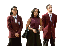 a man and two women are standing next to each other wearing maroon jackets