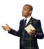 a man in a plaid suit and tie holds a piece of paper