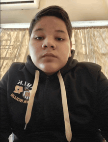 a boy wearing a black hoodie that says " objective " on it