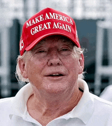 a man wearing a make america great again hat