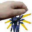 a person is holding a toy robot with yellow wings